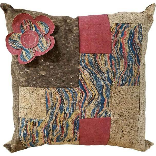 A red and tan throw pillow made from cork fabric